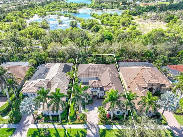 an aerial view of residential houses with outdoor space and street view