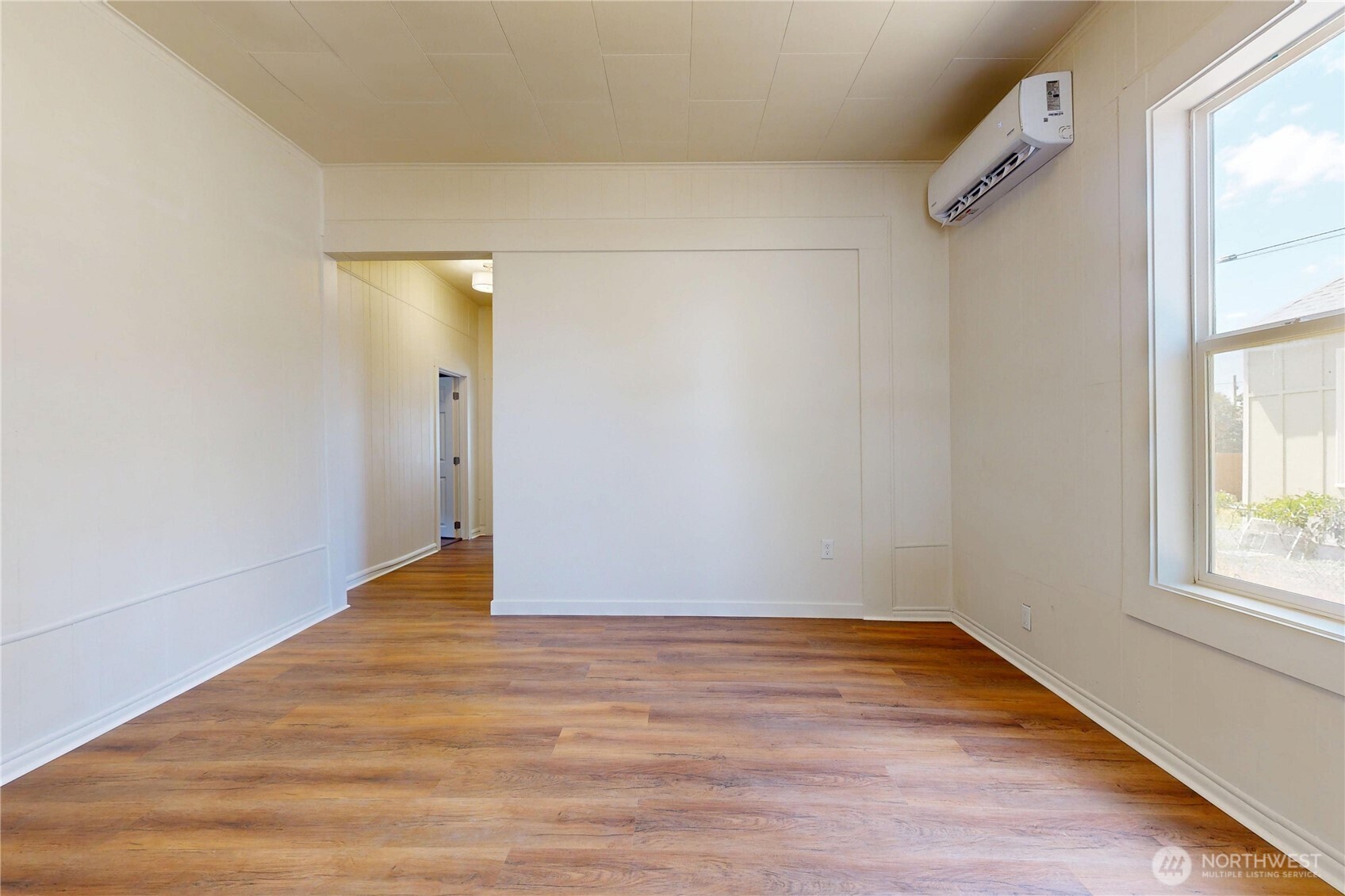 611 Southwest 3rd Street Pendleton, OR 97801 - Photo 3 of 21 a view of an empty room with wooden floor and a window