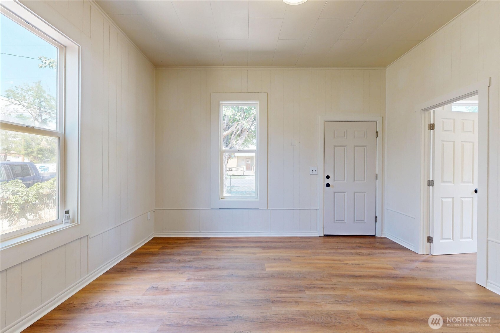 611 Southwest 3rd Street Pendleton, OR 97801 - Photo 5 of 21 an empty room with wooden floor and windows