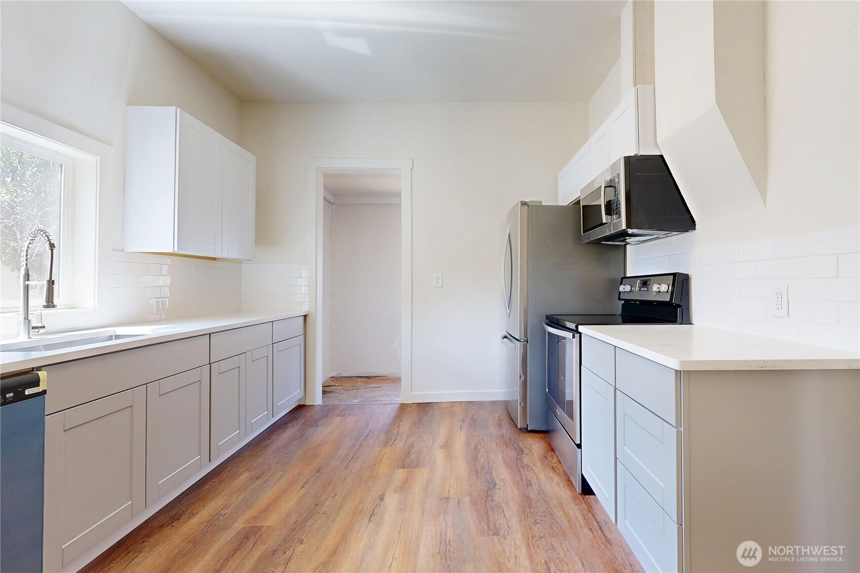 611 Southwest 3rd Street Pendleton, OR 97801 - Photo 6 of 21 a kitchen with a sink and wooden floor