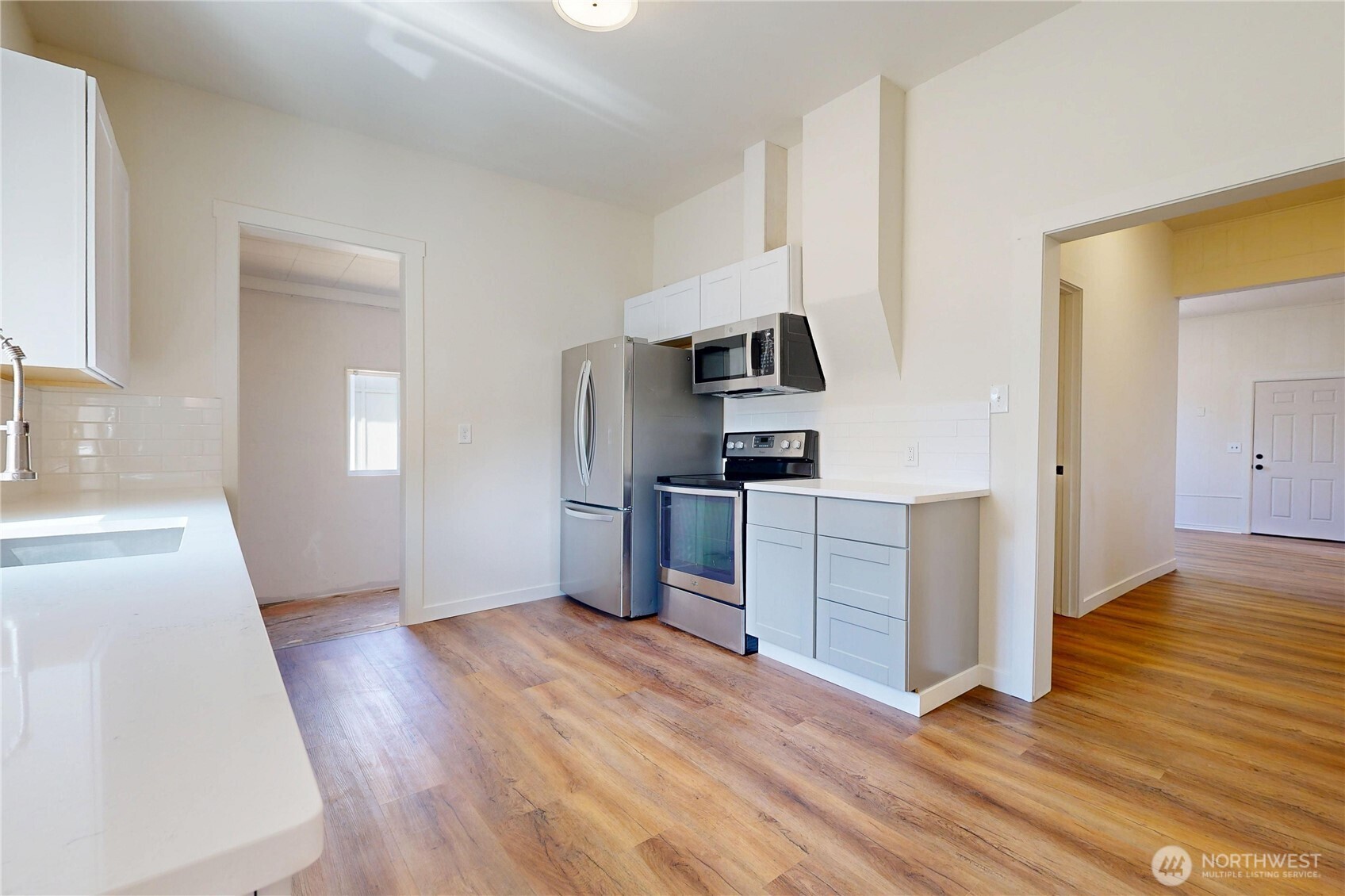 611 Southwest 3rd Street Pendleton, OR 97801 - Photo 7 of 21 a kitchen with a refrigerator and a stove top oven