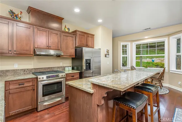 a kitchen with a stove a sink and a refrigerator