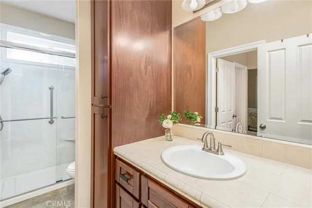 a bathroom with a granite countertop sink and a mirror