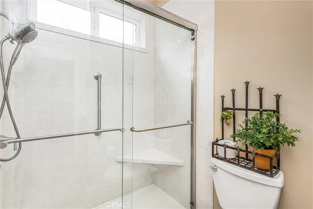 a bathroom with a shower and a toilet