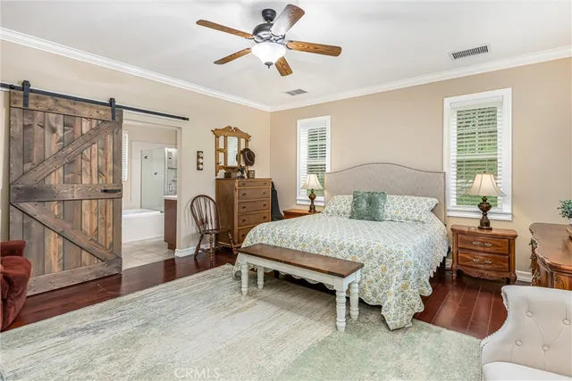 a spacious bedroom with a bed and a chandelier