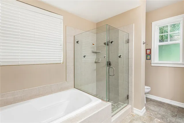 a bathroom with a bathtub and shower