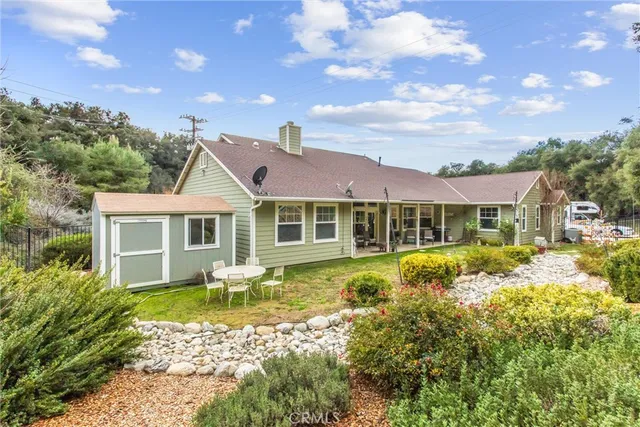 a front view of a house with a yard table and chairs