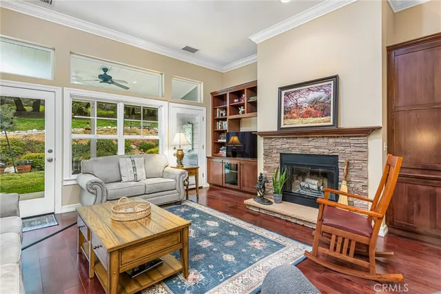 a living room with furniture a fireplace and a large window