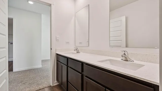 a bathroom with a double vanity sink a and mirror