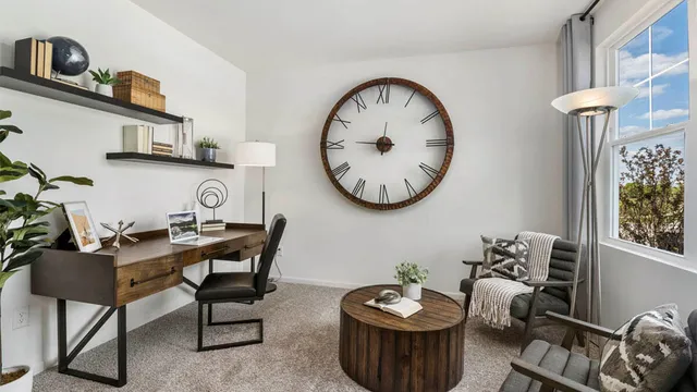 a view of a livingroom with furniture and a kitchen