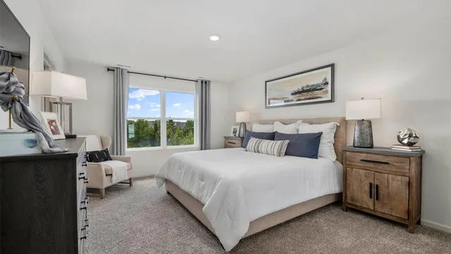 a bedroom with a bed wooden floor and window
