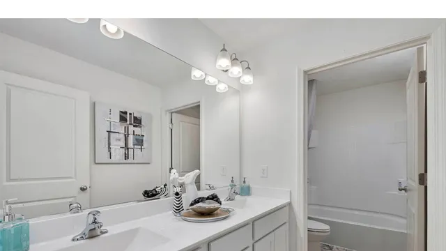 a bathroom with a sink vanity and a mirror