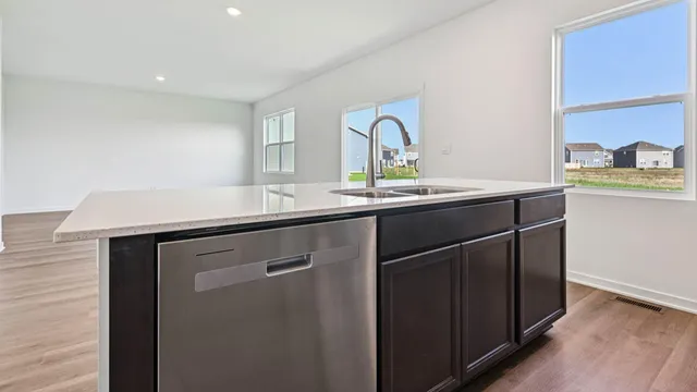 a kitchen with a sink and a refrigerator