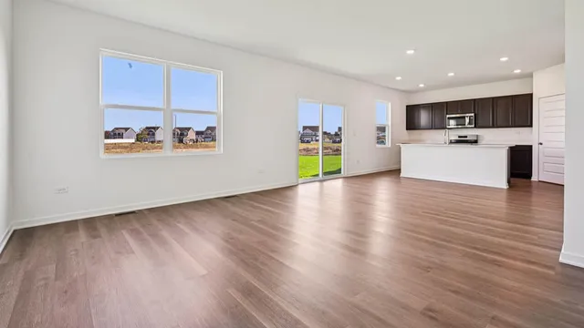 a view of kitchen with cabinets and wooden floor