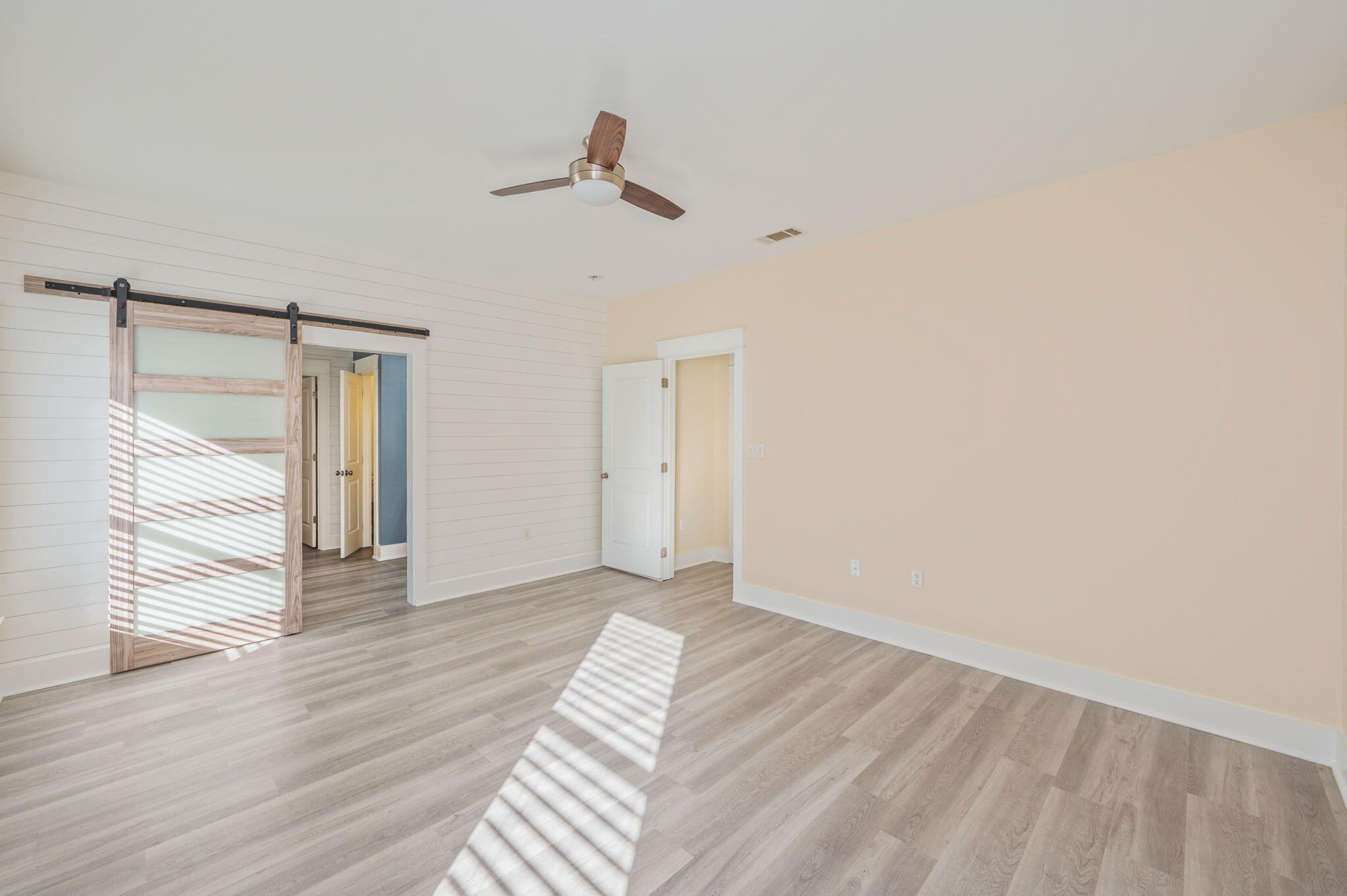 3120 Pinot Way Crestview, FL 32536 - Photo 10 of 37 a view of an empty room with wooden floor and a window