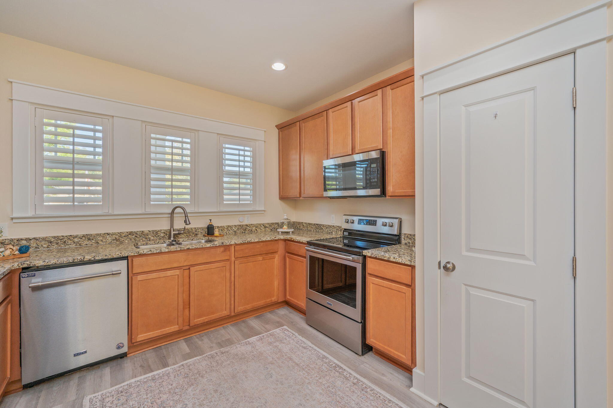 3120 Pinot Way Crestview, FL 32536 - Photo 6 of 37 a kitchen with stainless steel appliances granite countertop a stove sink microwave and window