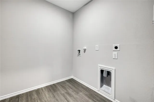 a view of storage and utility room with wooden floor