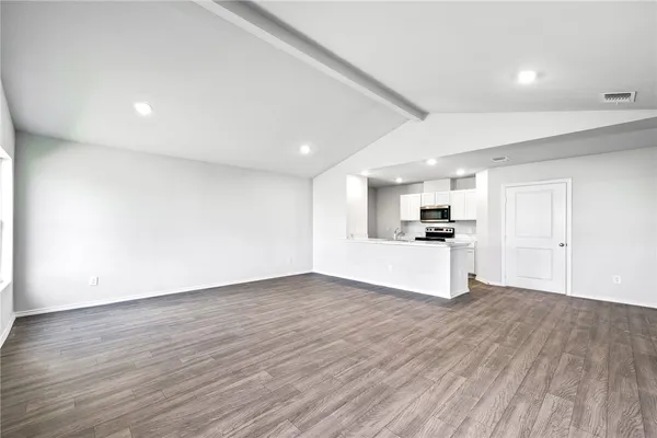 a view of kitchen with wooden floor and windows