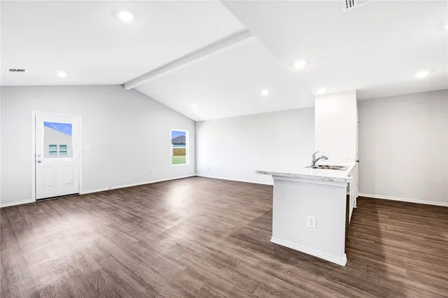 a view of kitchen and hall with wooden floor