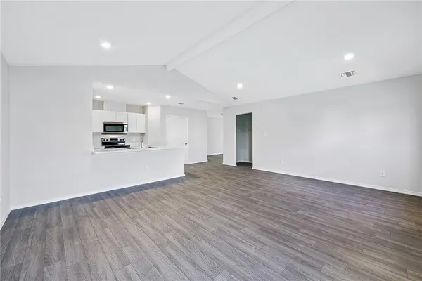 a view of kitchen with cabinets and wooden floor