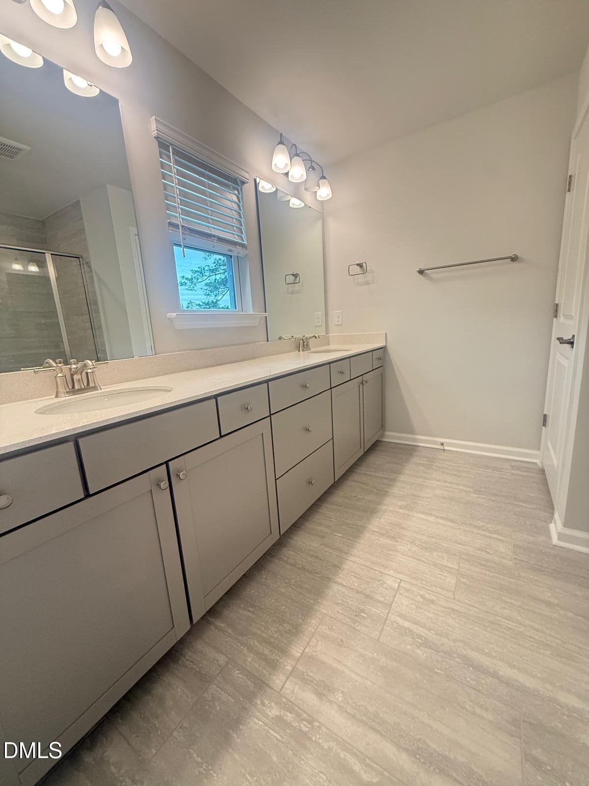 2126 Grubstake Street Apex, NC 27523 - Photo 12 of 22 a bathroom with a sink mirror and a shower