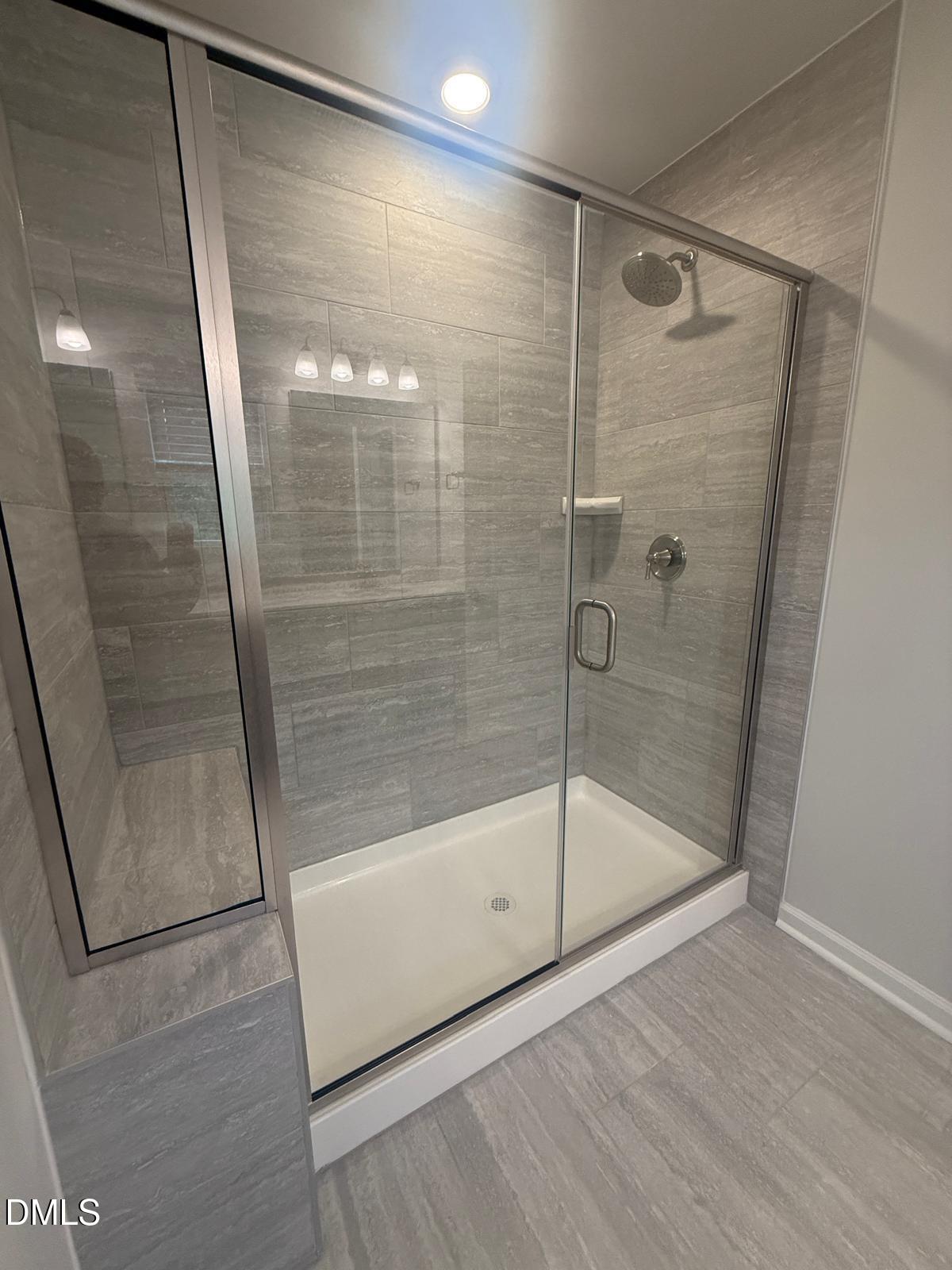 2126 Grubstake Street Apex, NC 27523 - Photo 13 of 22 a bathroom with a glass shower door