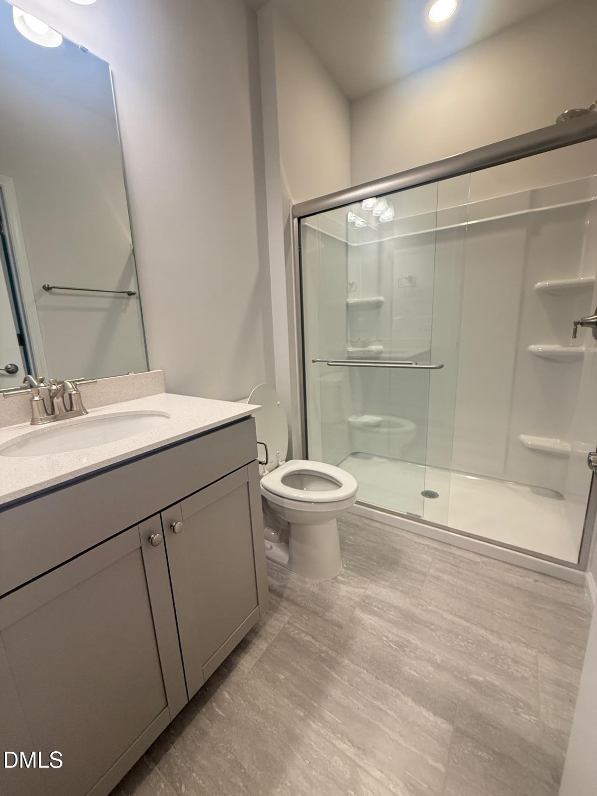 2126 Grubstake Street Apex, NC 27523 - Photo 21 of 22 a bathroom with a sink a toilet and shower