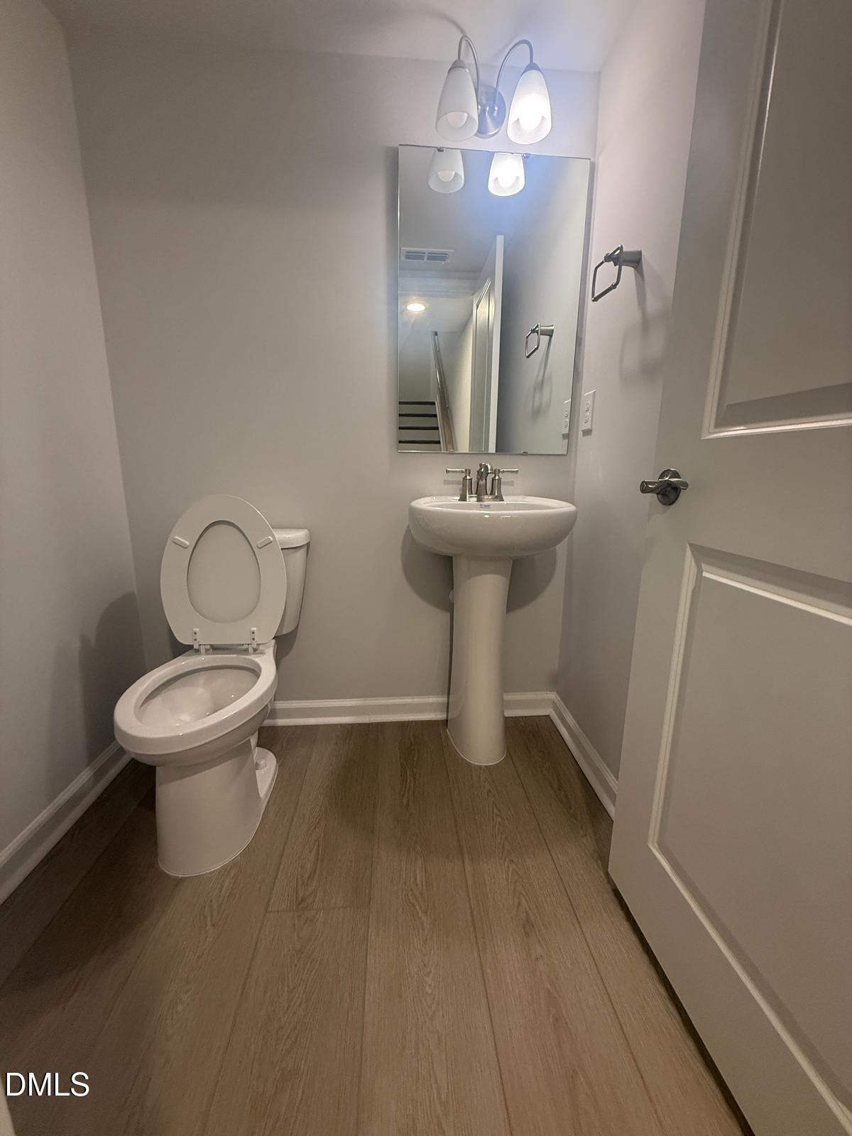 2126 Grubstake Street Apex, NC 27523 - Photo 9 of 22 a bathroom with a toilet sink and mirror