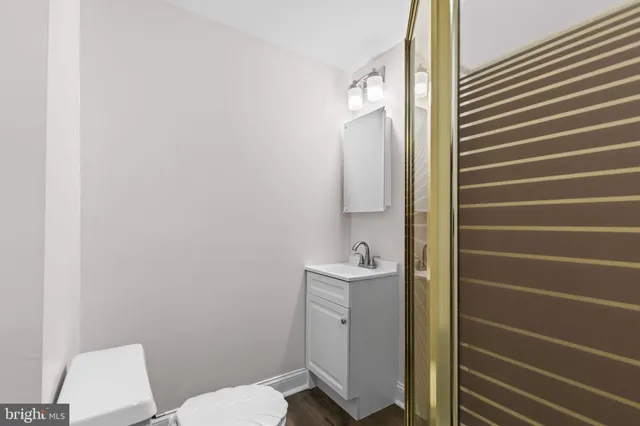 a bathroom with a toilet a sink and mirror