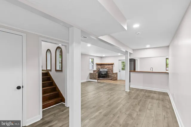 a view of a livingroom with wooden floor and staircase
