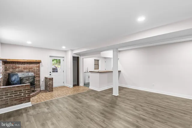 a view of a kitchen with a sink and a fireplace