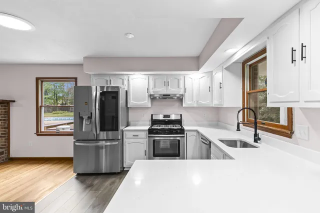 a kitchen with granite countertop a stove and a sink