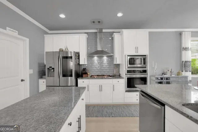 a kitchen with refrigerator and cabinets