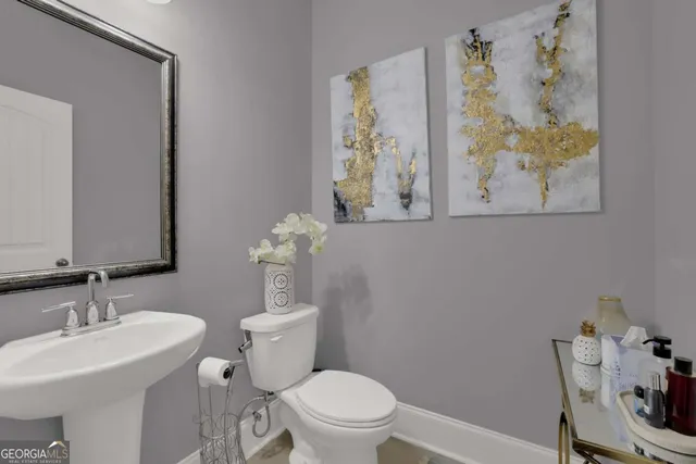 a bathroom with a toilet a sink and a mirror