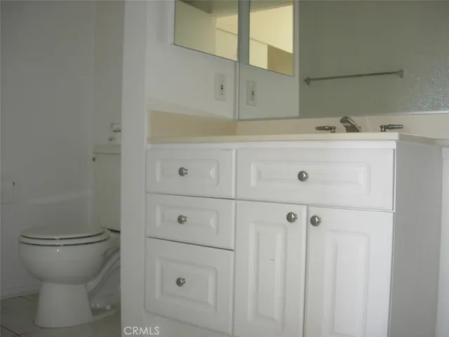 a bathroom with a sink toilet and vanity