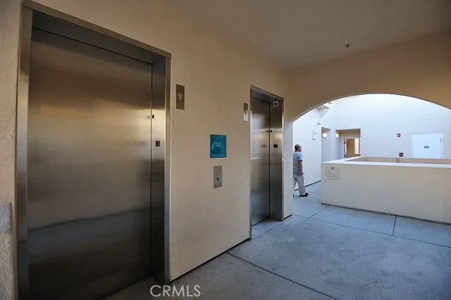 a view of a hallway with closet and a window
