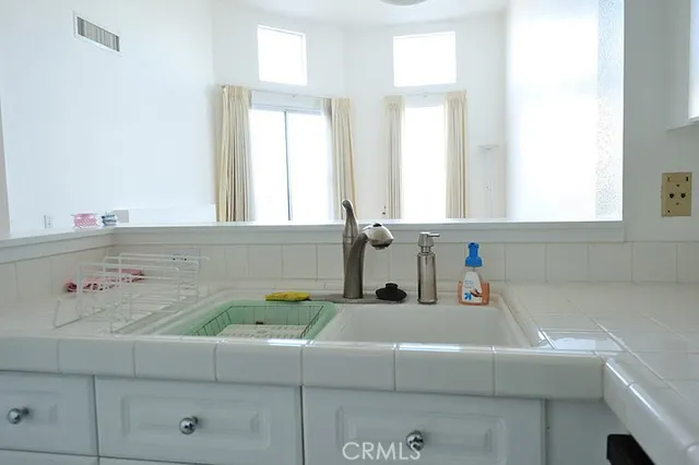 a bathroom with a tub sink and window