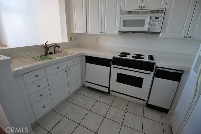 a kitchen with cabinets and appliances