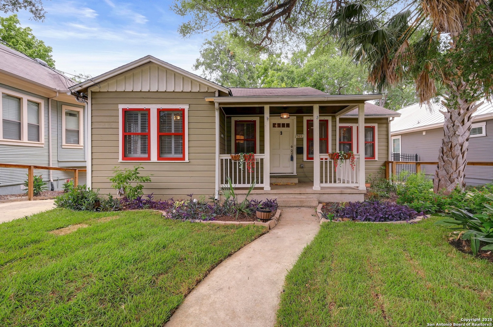 a front view of a house with a garden and plants