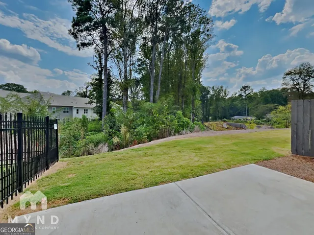 a view of a patio with table and chairs and potted plants