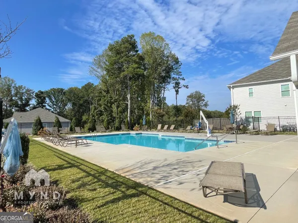 a living room with furniture kitchen view and a chandelier