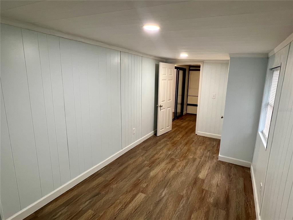 3000 Clarcona Road, Unit 410 Apopka, FL 32703 - Photo 5 of 11 a view of hallway with wooden floor