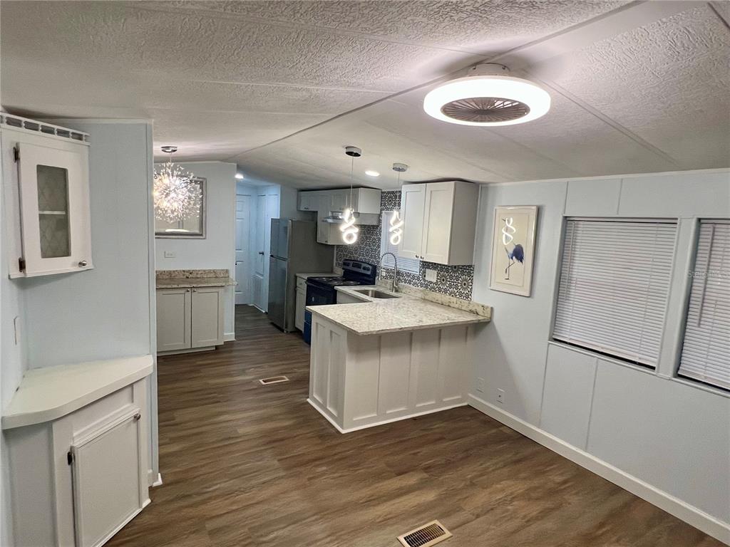 3000 Clarcona Road, Unit 410 Apopka, FL 32703 - Photo 6 of 11 a kitchen with a refrigerator sink and cabinets