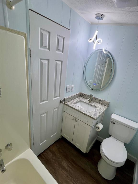 3000 Clarcona Road, Unit 410 Apopka, FL 32703 - Photo 10 of 11 a bathroom with a granite countertop toilet sink and mirror