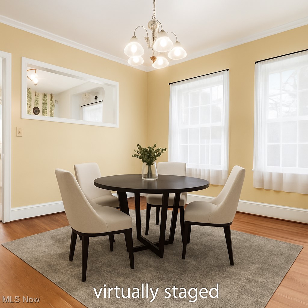 427 Harding Road Zanesville, OH 43701 - Photo 11 of 23 Dining area with light wood-style flooring, a chandelier, and ornamental molding