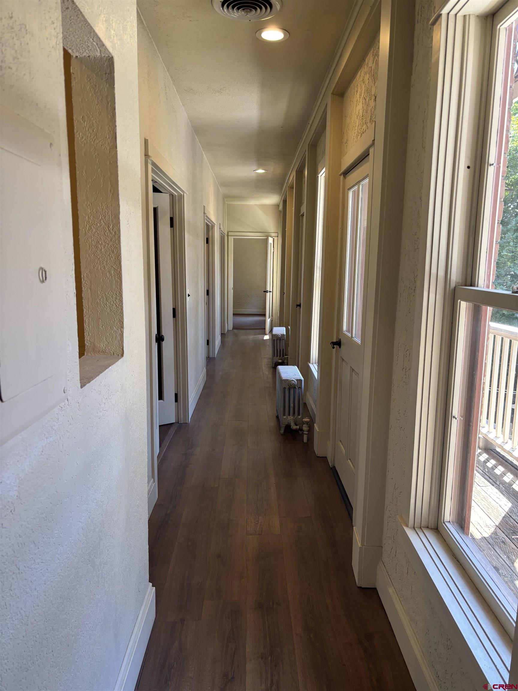 552 Main Avenue, Unit B Durango, CO 81301 - Photo 2 of 12 a view of a hallway with wooden floor and staircase