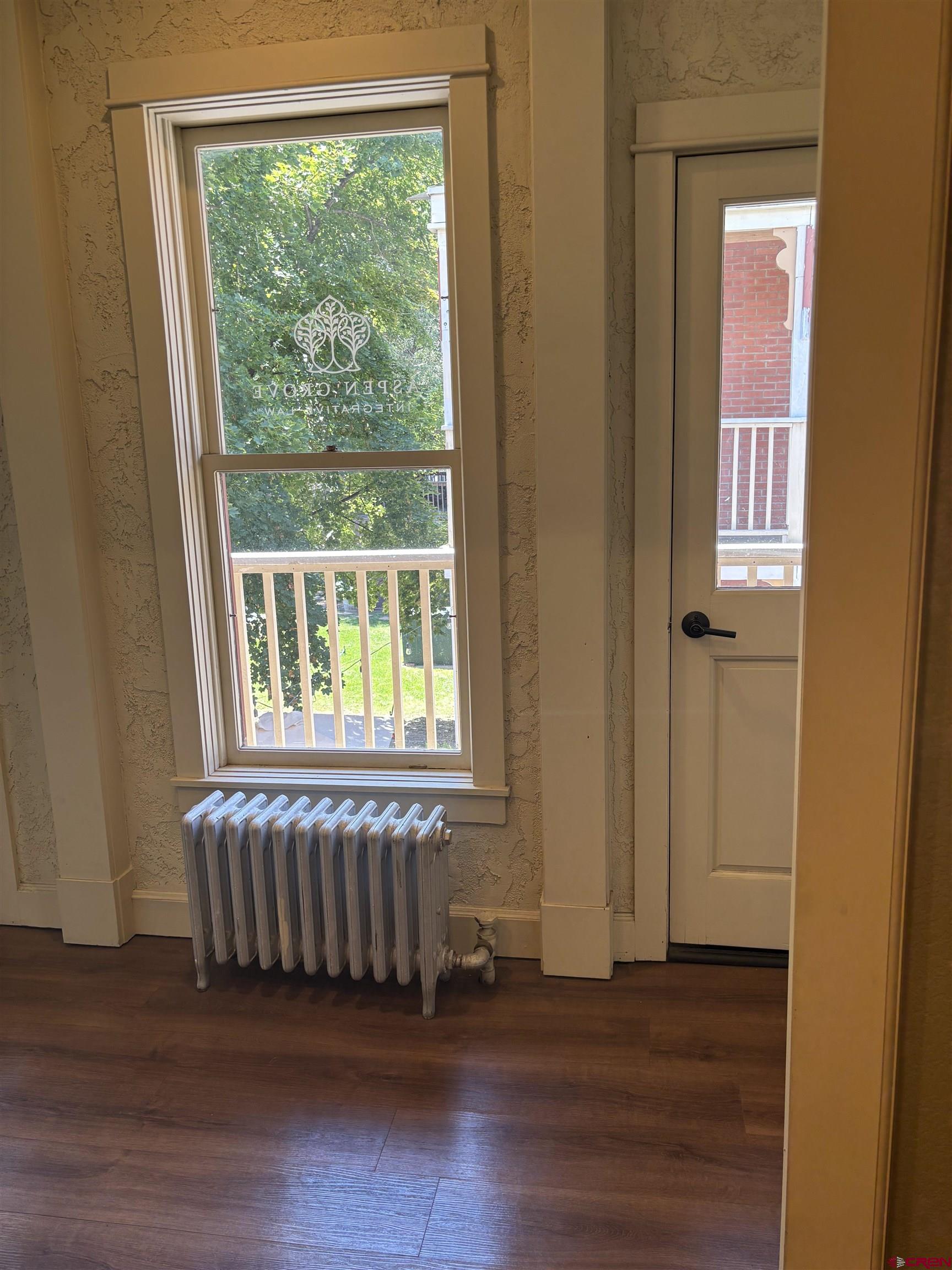 552 Main Avenue, Unit B Durango, CO 81301 - Photo 4 of 12 an empty room with wooden floor and windows