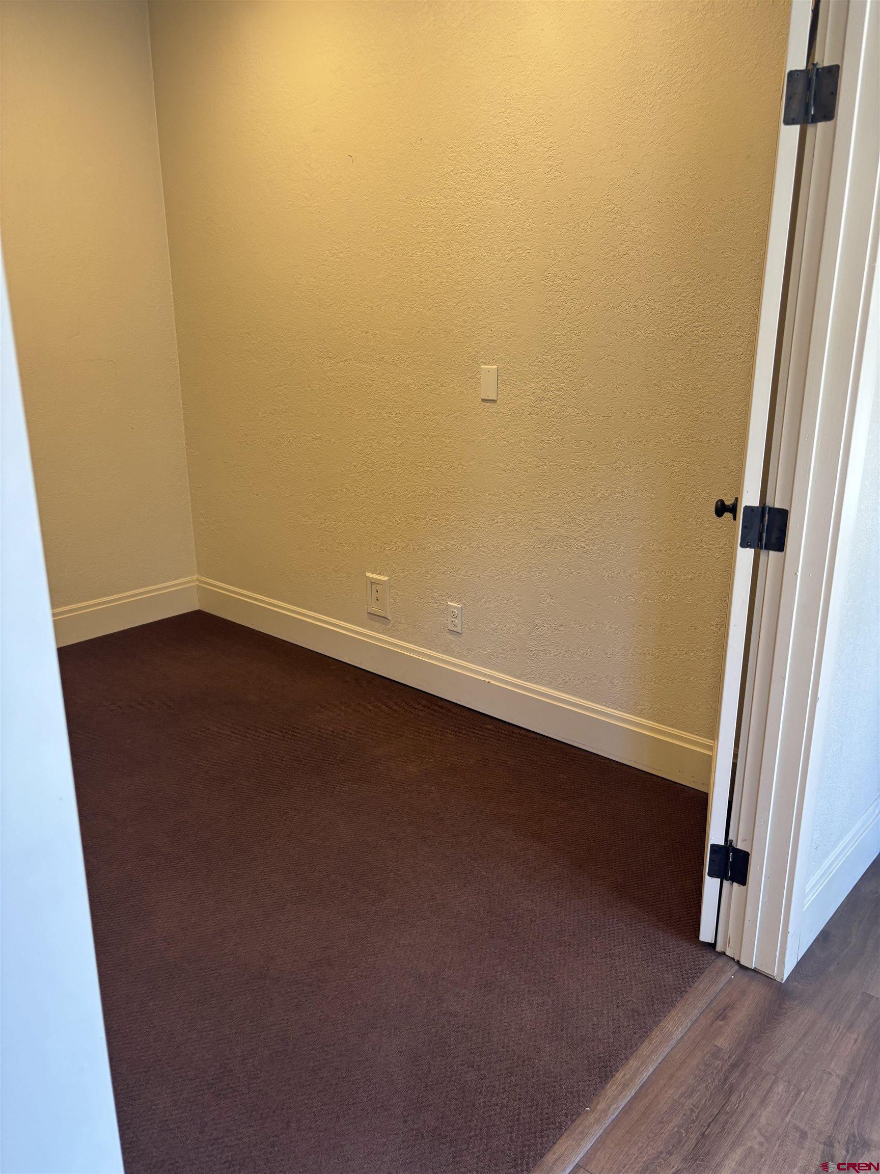 552 Main Avenue, Unit B Durango, CO 81301 - Photo 8 of 12 an empty room with wooden floor and entrance