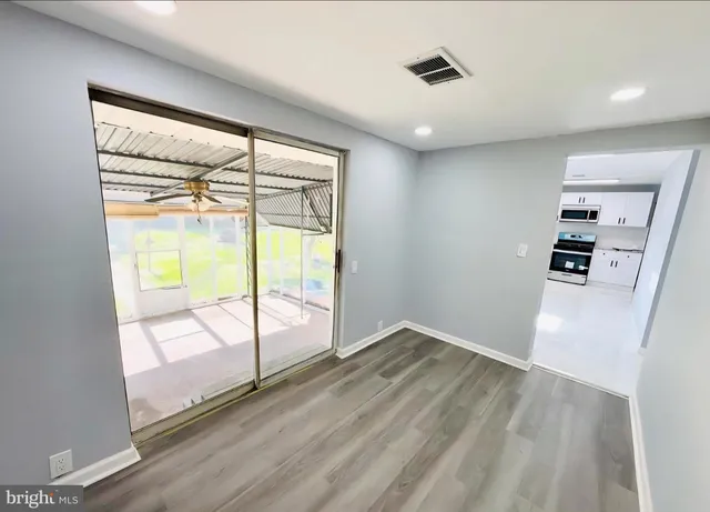 wooden floor in an empty room with a window