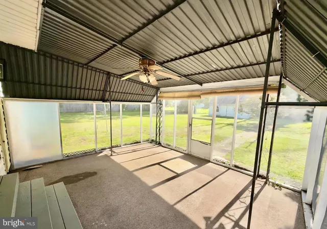 a view of an empty room with a floor to ceiling window